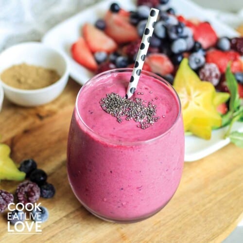 Camu camu smoothie on pink background surrounded by blackberries
