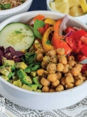 Mediterranean grain bowl in white dish with fork