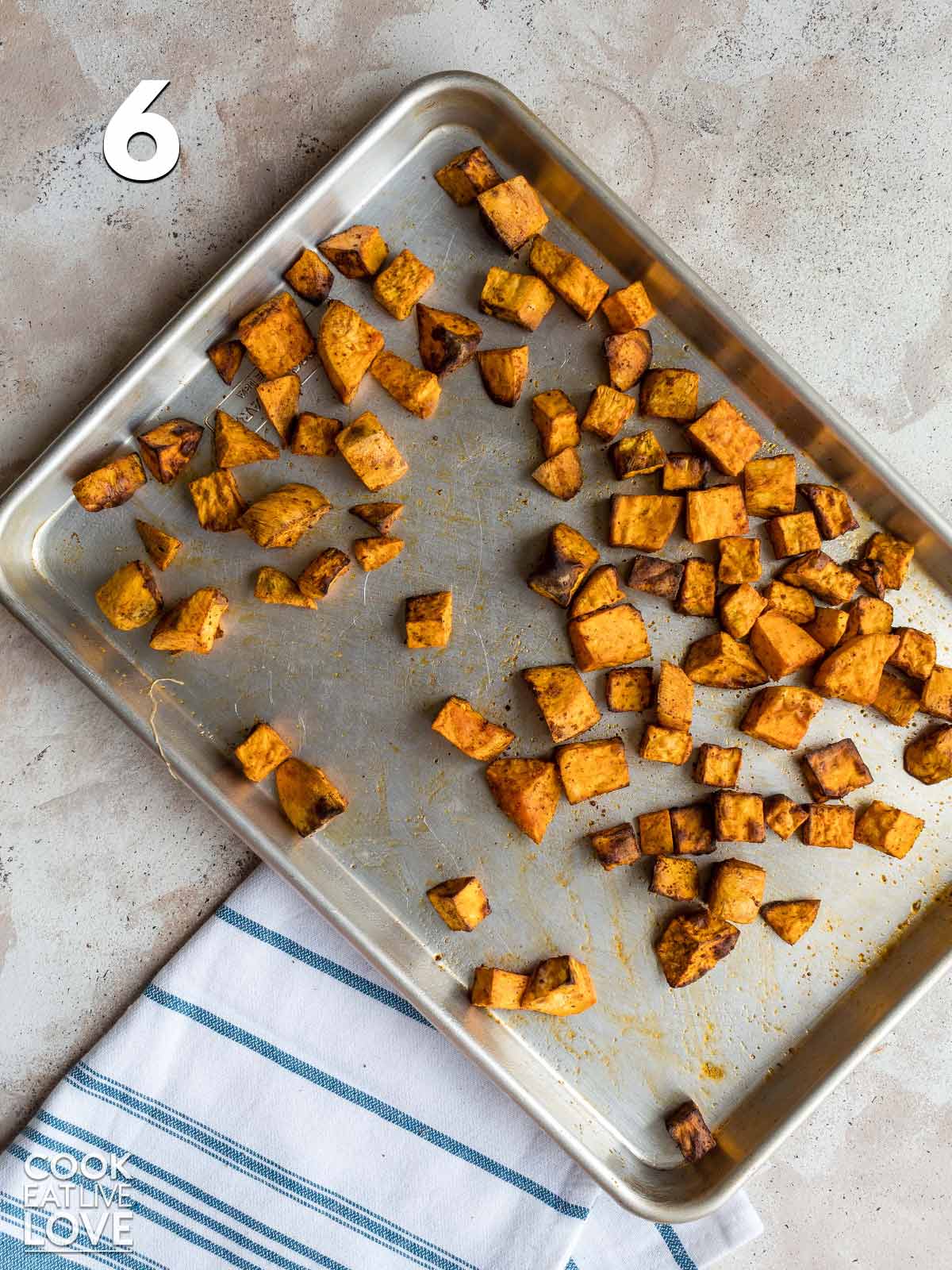 Cooked sweet potatoes on a baking sheet.