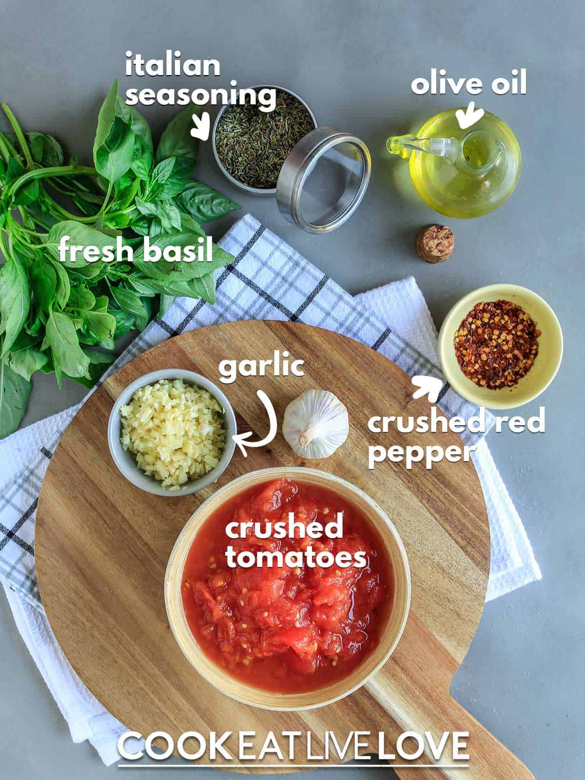 Ingredients to make hearty marinara sauce on table with text