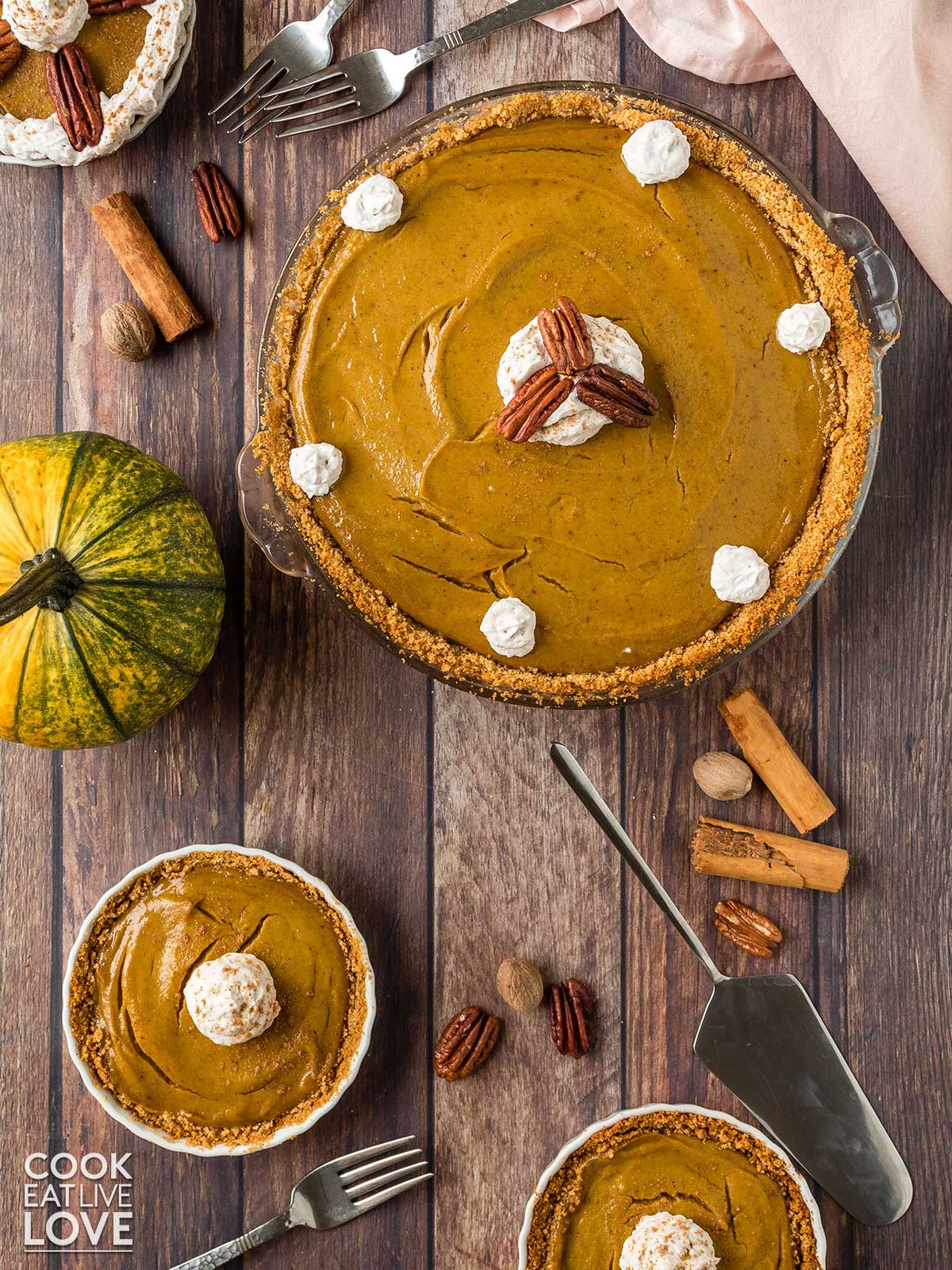 Pumpkin pie in pan on counter cut into slices