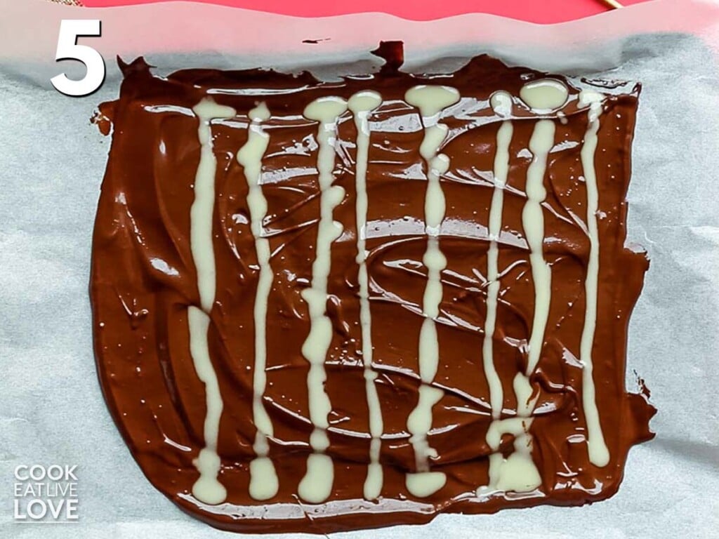 White chocolate is drizzled over dark chocolate.