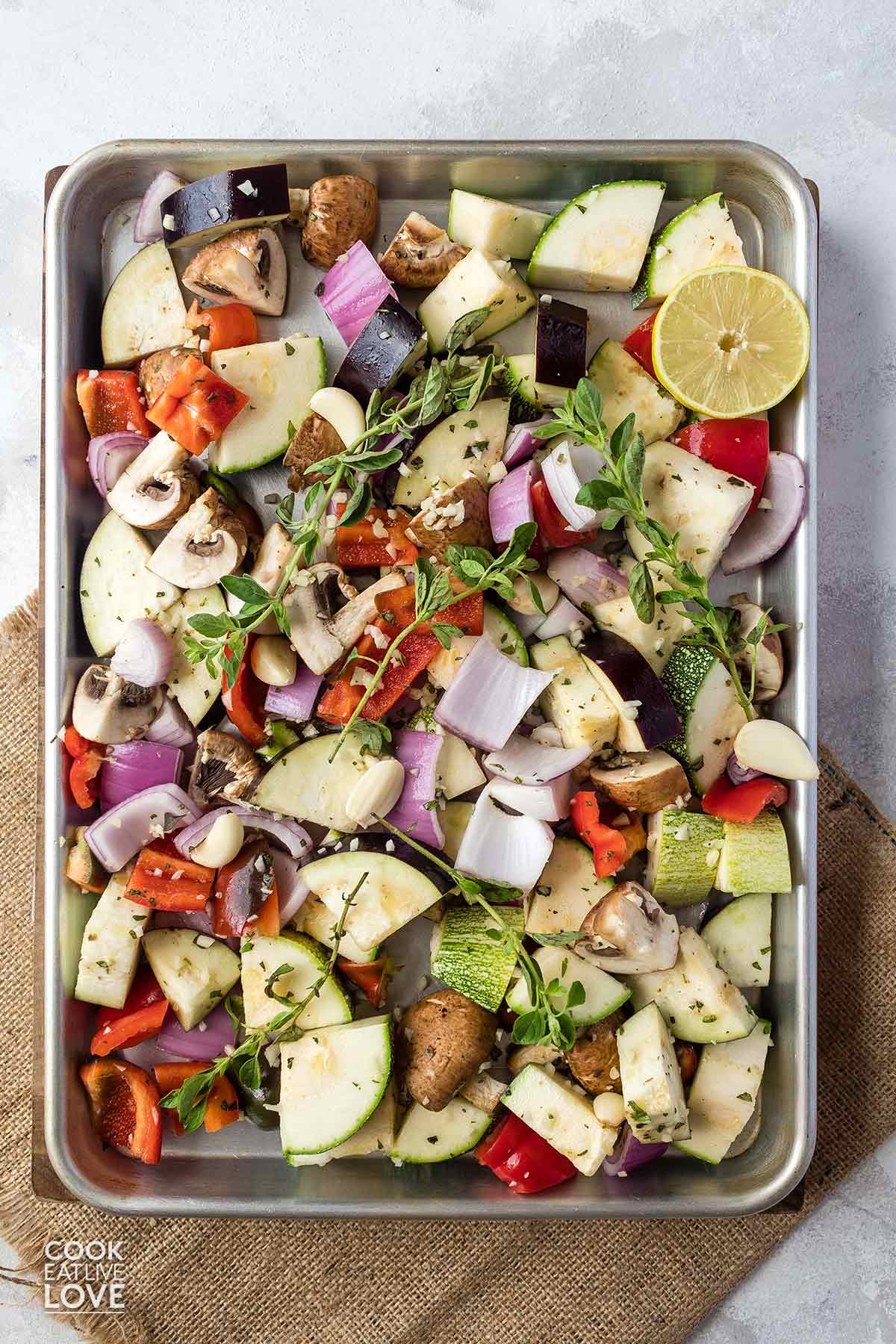 Tray of marinated vegetables on baking tray ready for the oven.
