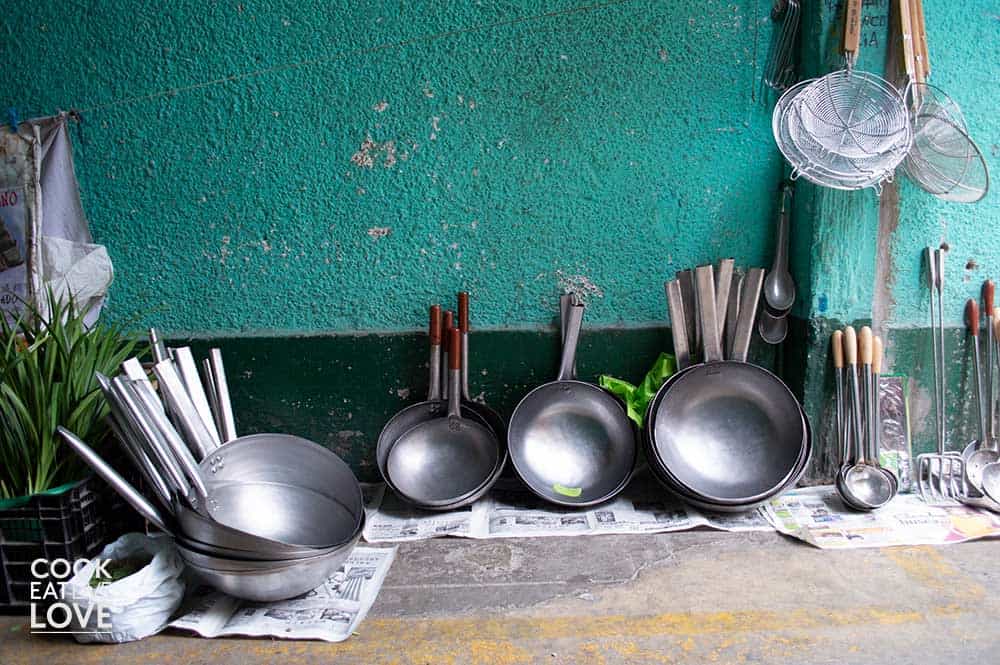 Handmade pots and pans sold by street vendor in alley of Barrio Chino