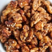 Bowl of glazed walnuts on a table