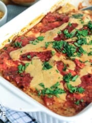 White casserole dish on the table with zucchini lasagna