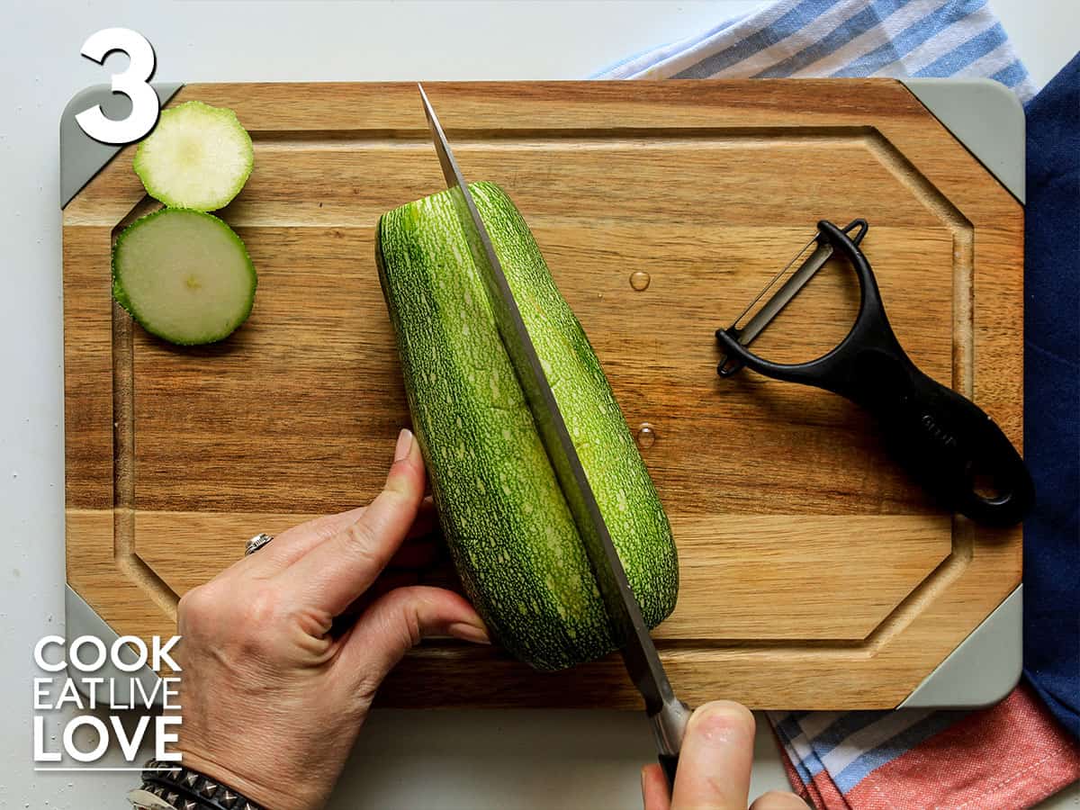 Zucchini on cutting board to cut in half