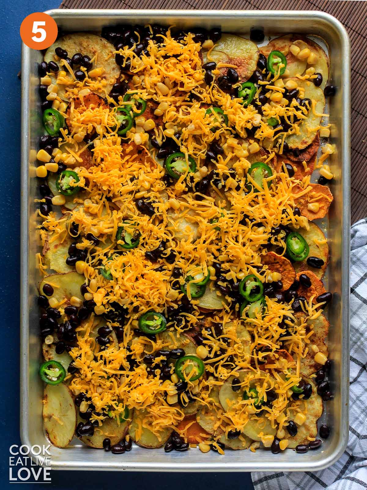 Beans, corn, jalapenos and cheese added to top of nachos.