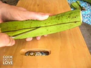 Use a knife to cut along the peel of the plantain