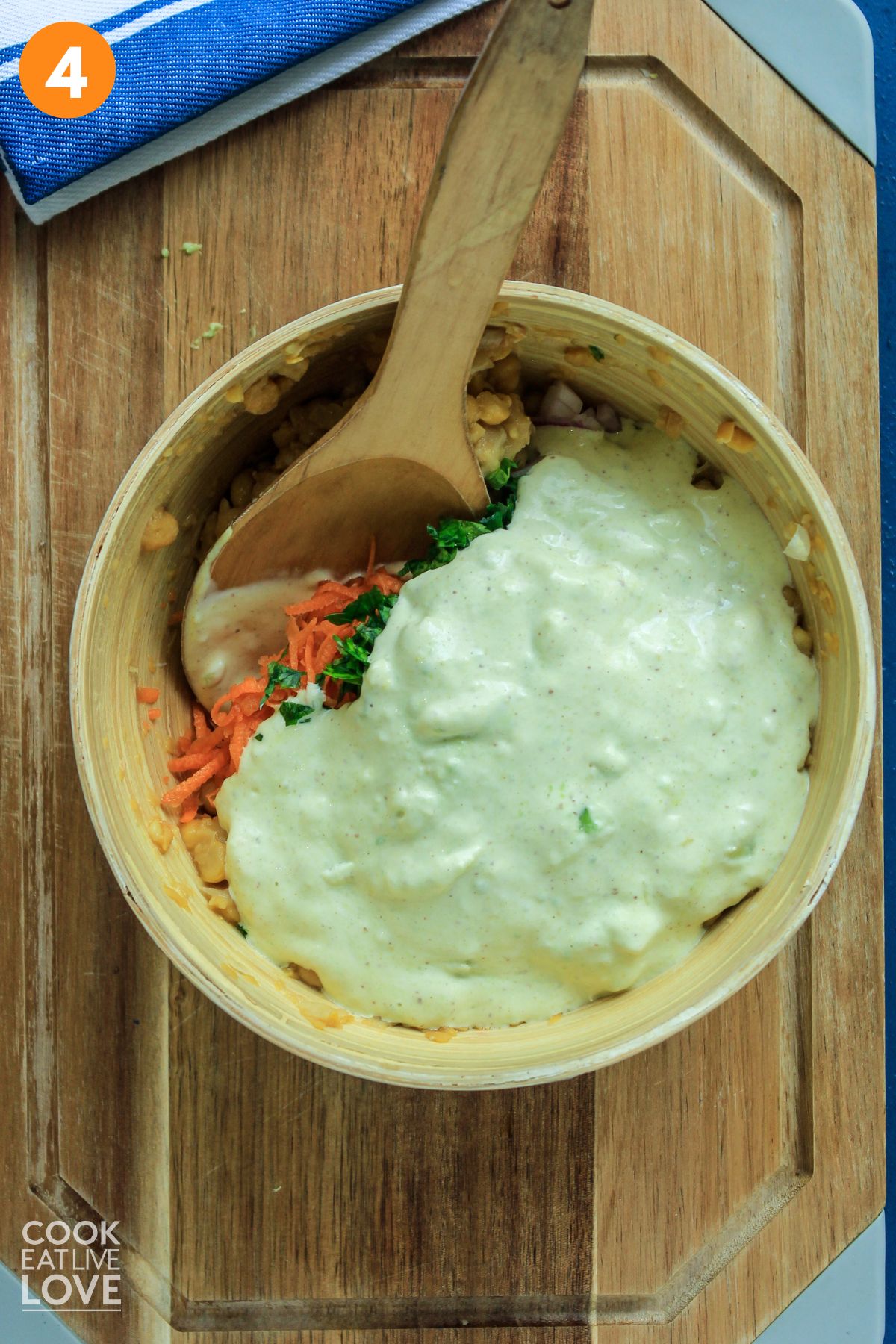 Dressing added to the veggies and smashed chickpeas. 