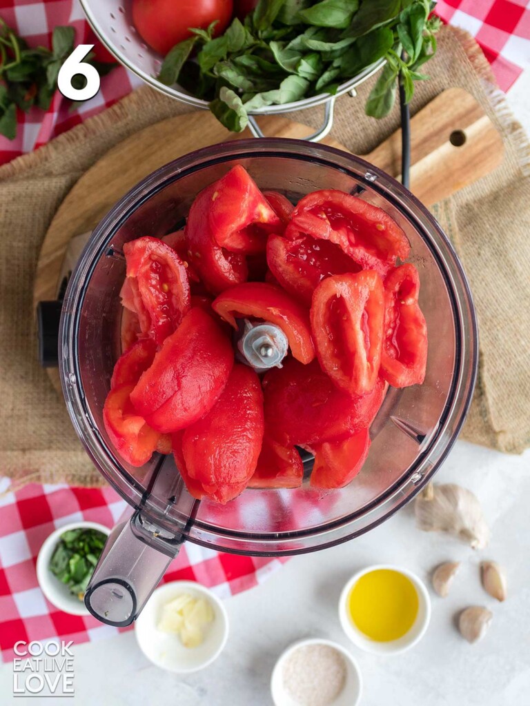 Cut tomatoes in the food processor to make fresh tomato pizza sauce.