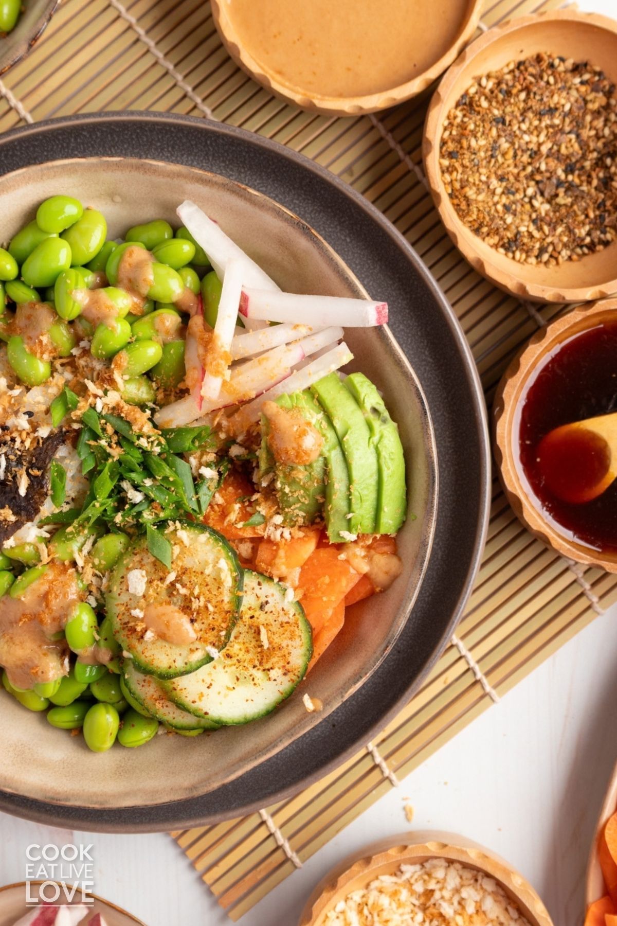 A vegetarian sushi bowl with only half of the bowl inthe frame.