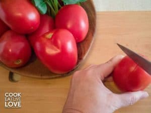 Cutting an "x" on the bottom of a tomato