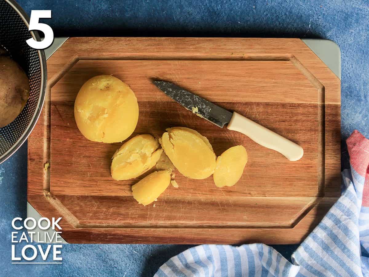 Potatoes sliced on a cutting board