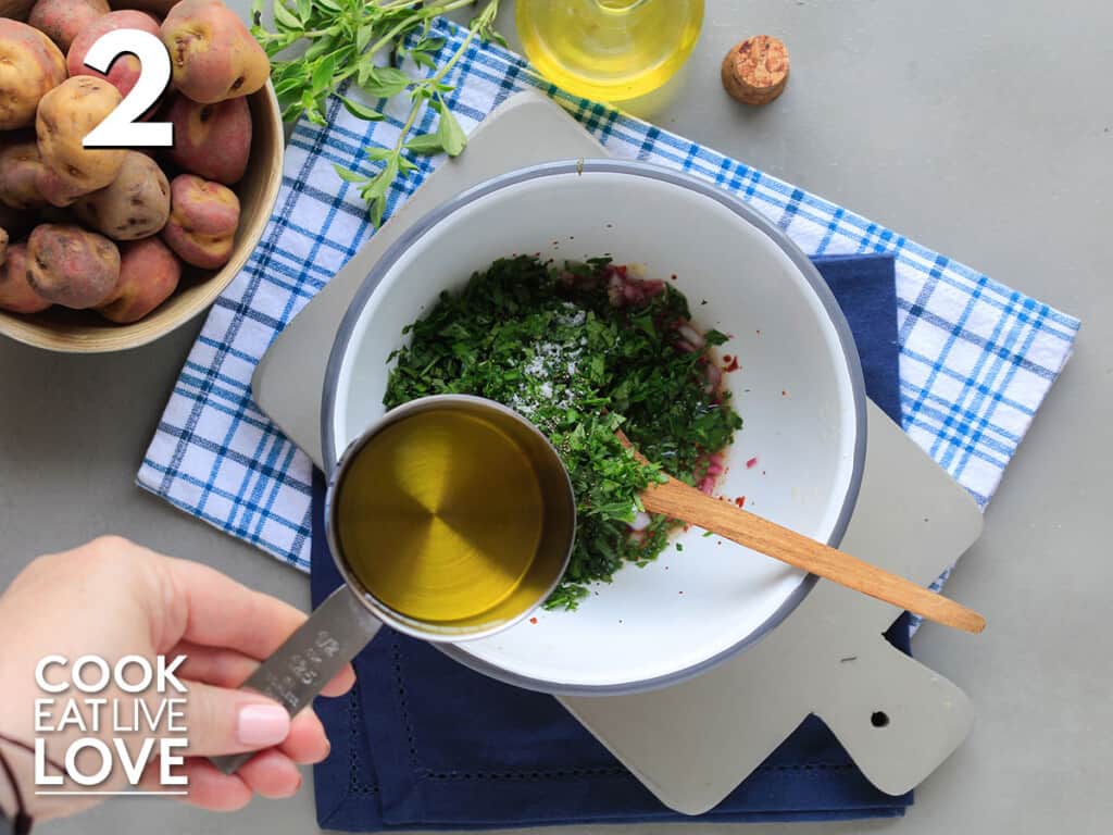 Adding olive oil to ingredients in a bowl