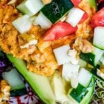 Pinterest graphic with image of stuffed avocado and text on top.