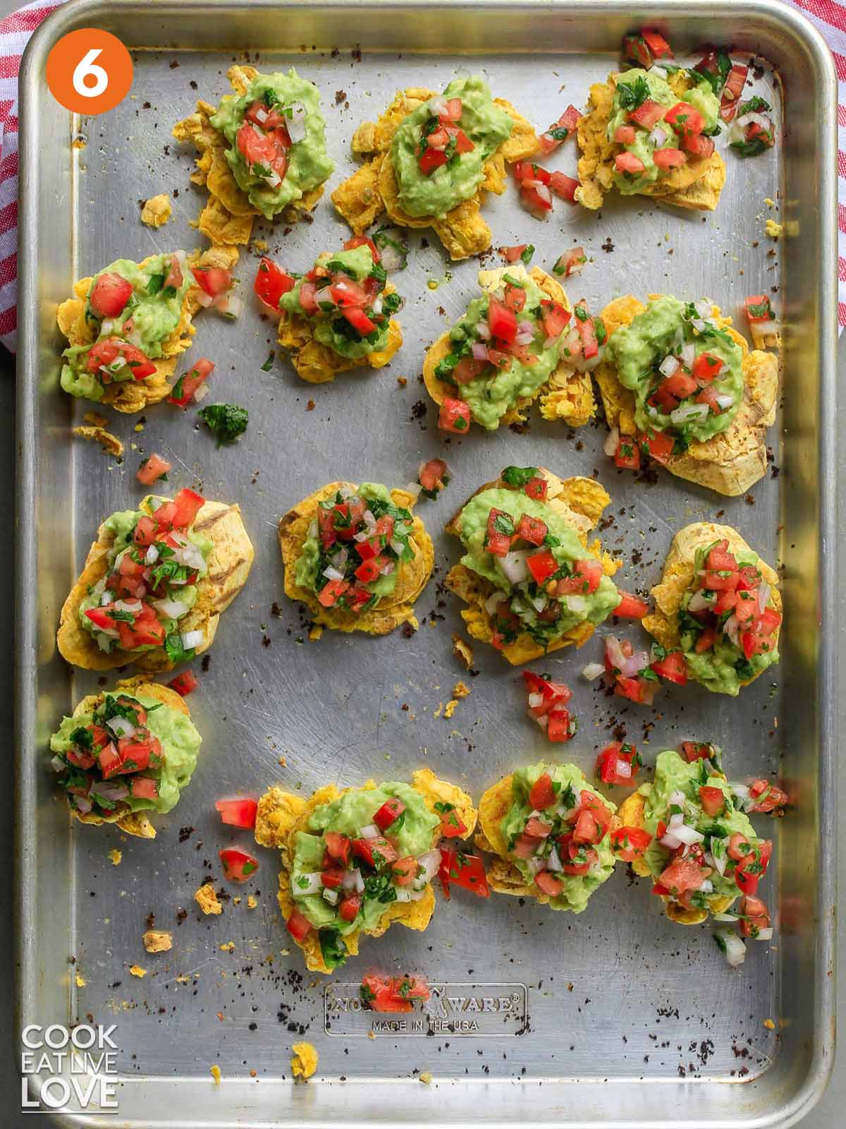Baked tostones are topped and ready to eat on platter.