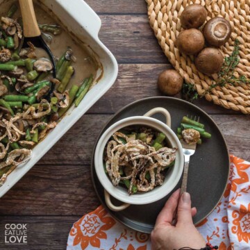 Vegan green bean casserole in large casserole dish and small round casserole dish.