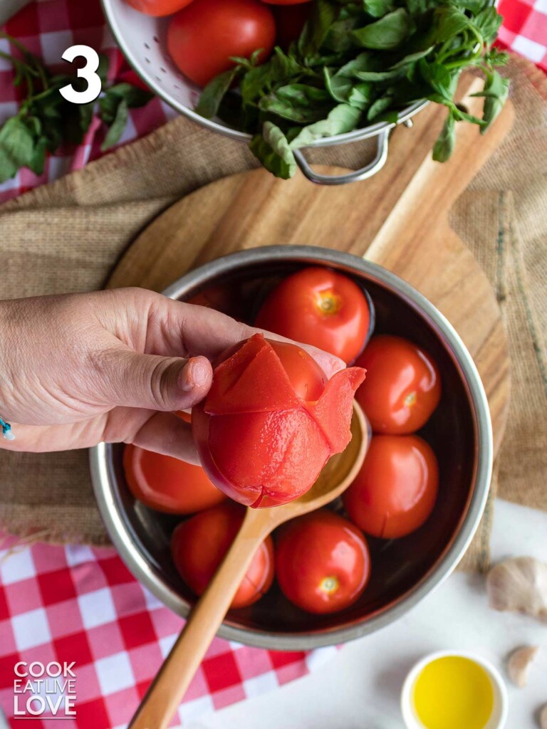 Removing the peel from the tomatoes.