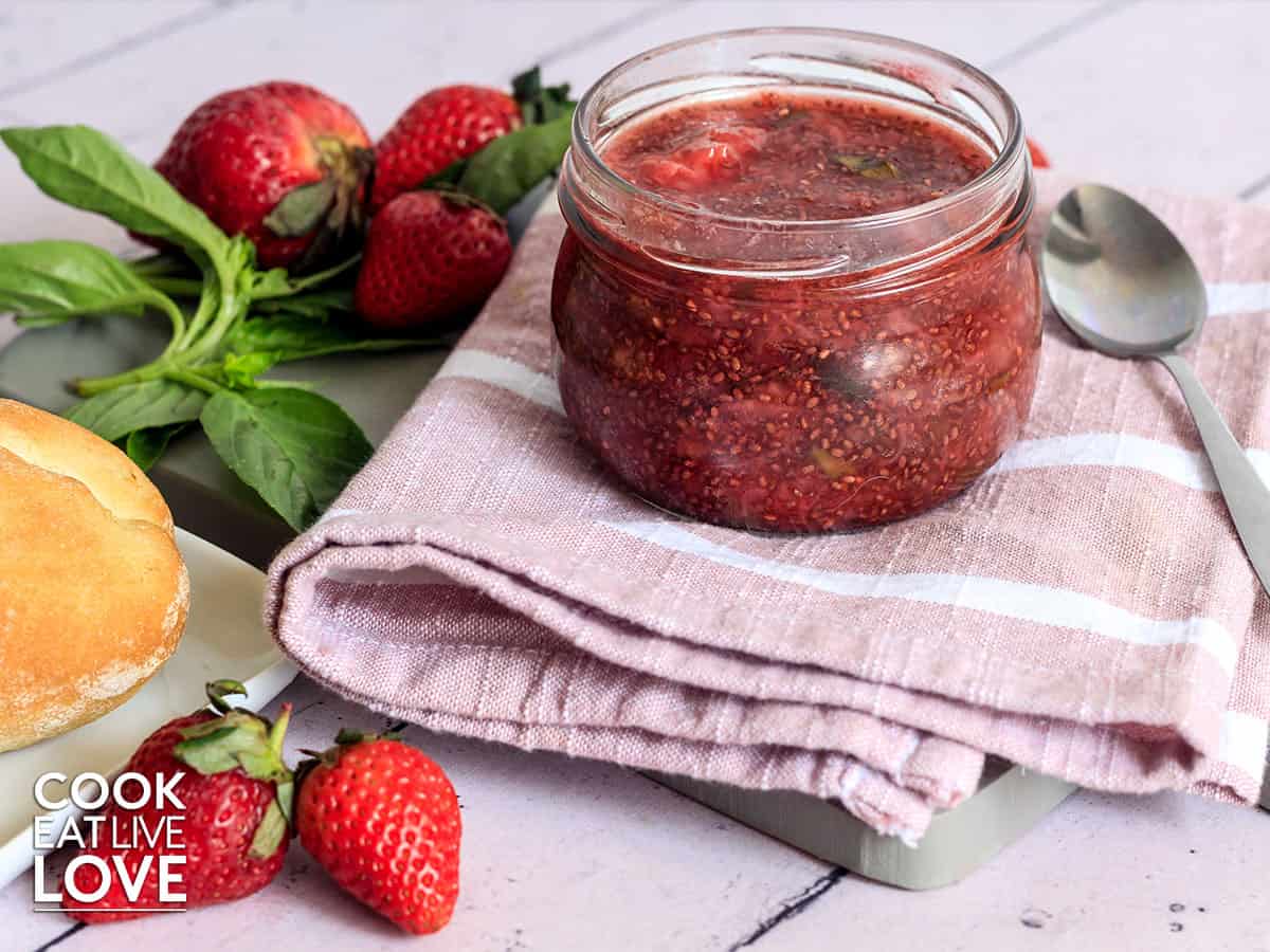 Strawberry basil jam in jar on the table