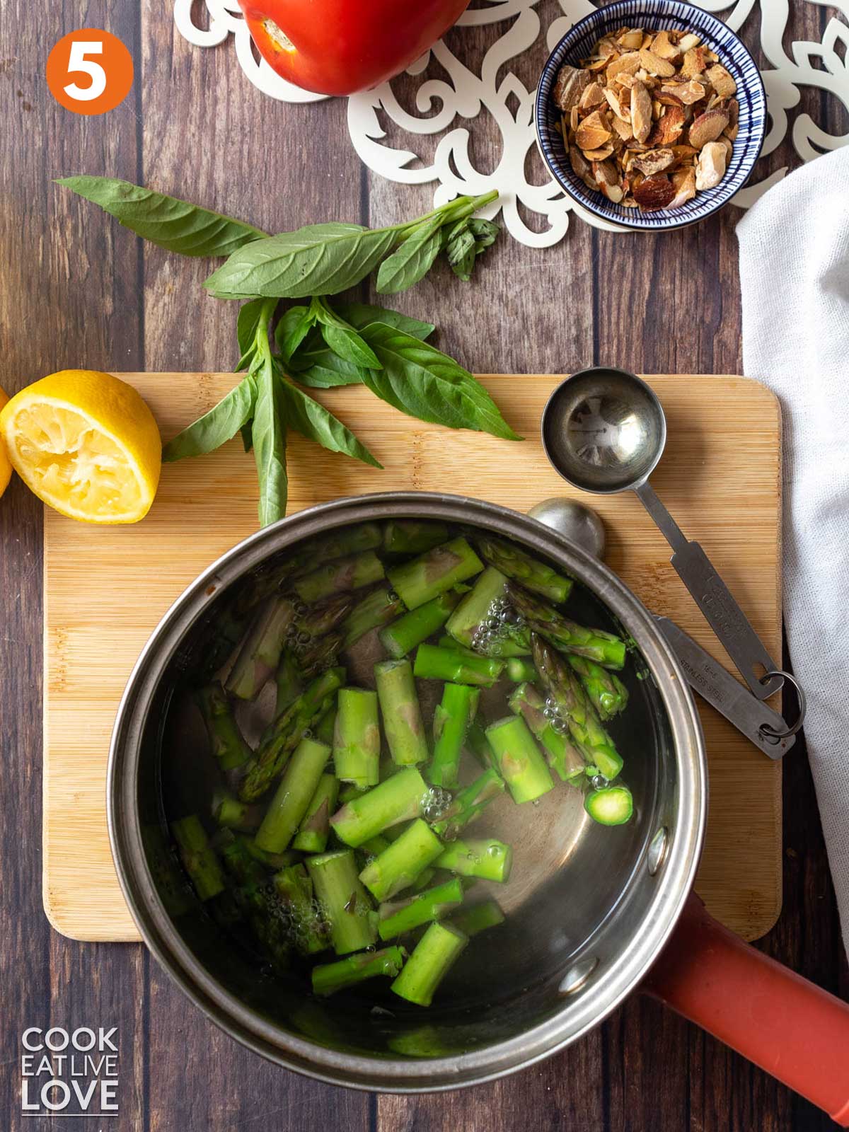 Asparagus cooking in a saucepan with water.