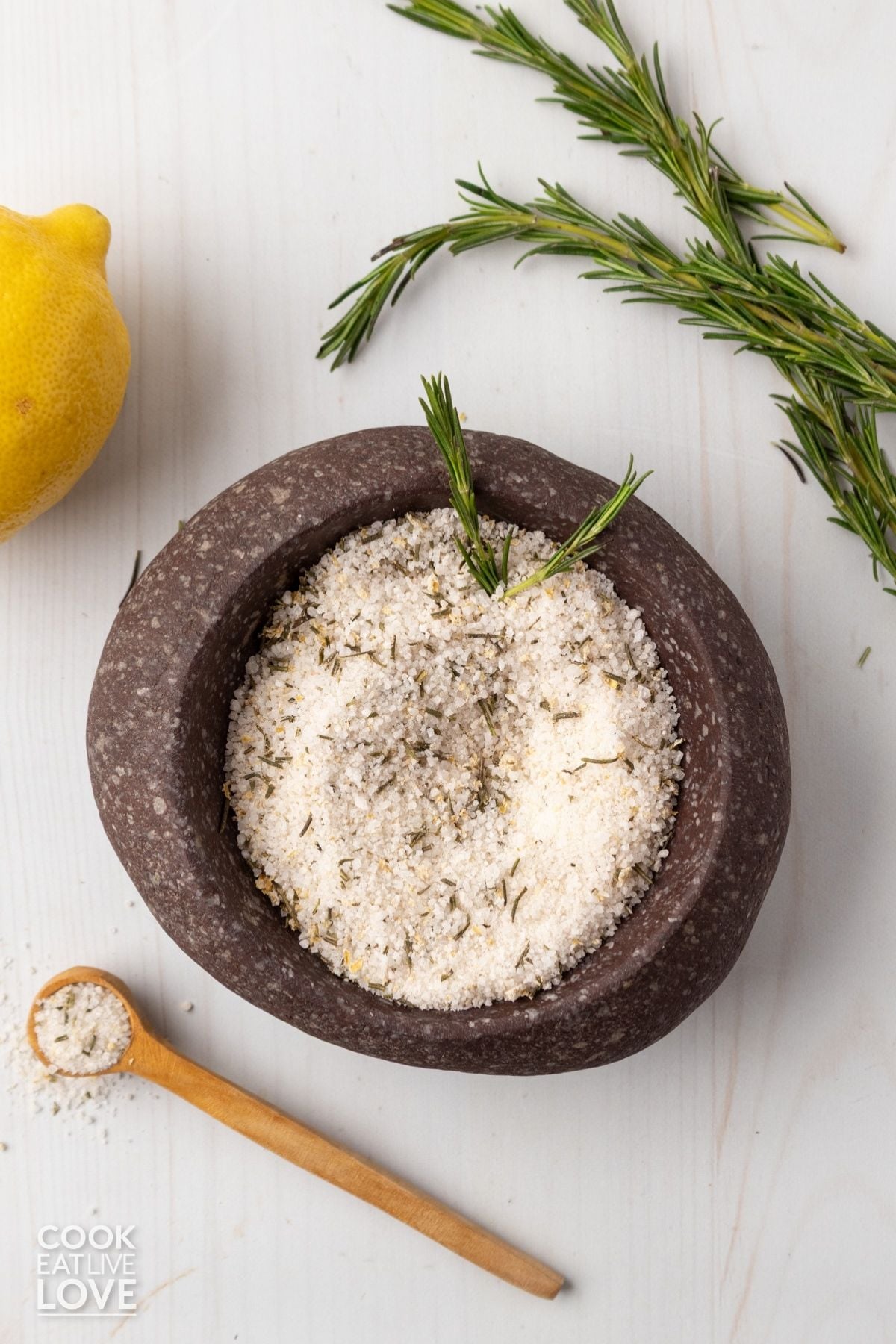 A brown dish full of rosemary salt. 