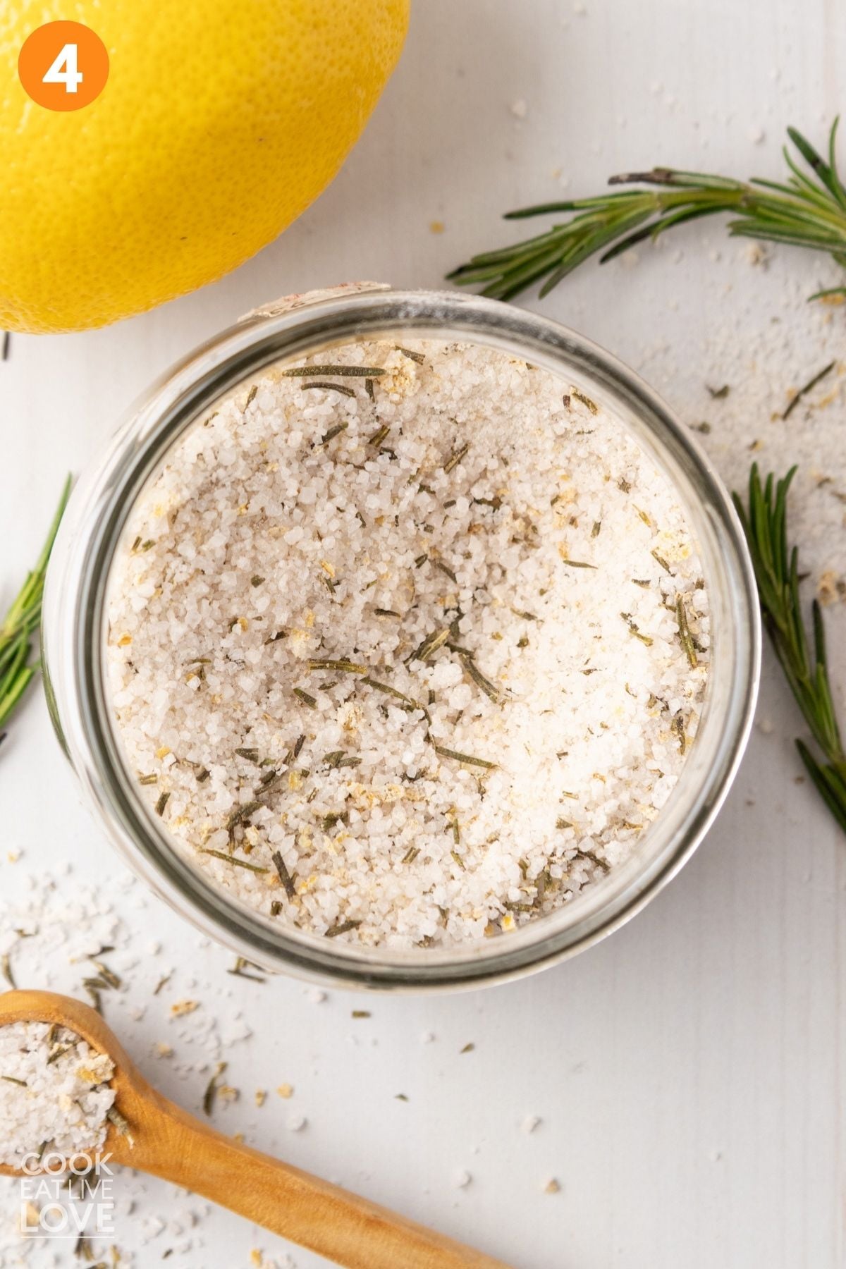 Rosemary salt added to a jar. 