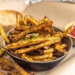 Pin for pinterest graphic for baked fries with image of fries in a bowl with text on top.