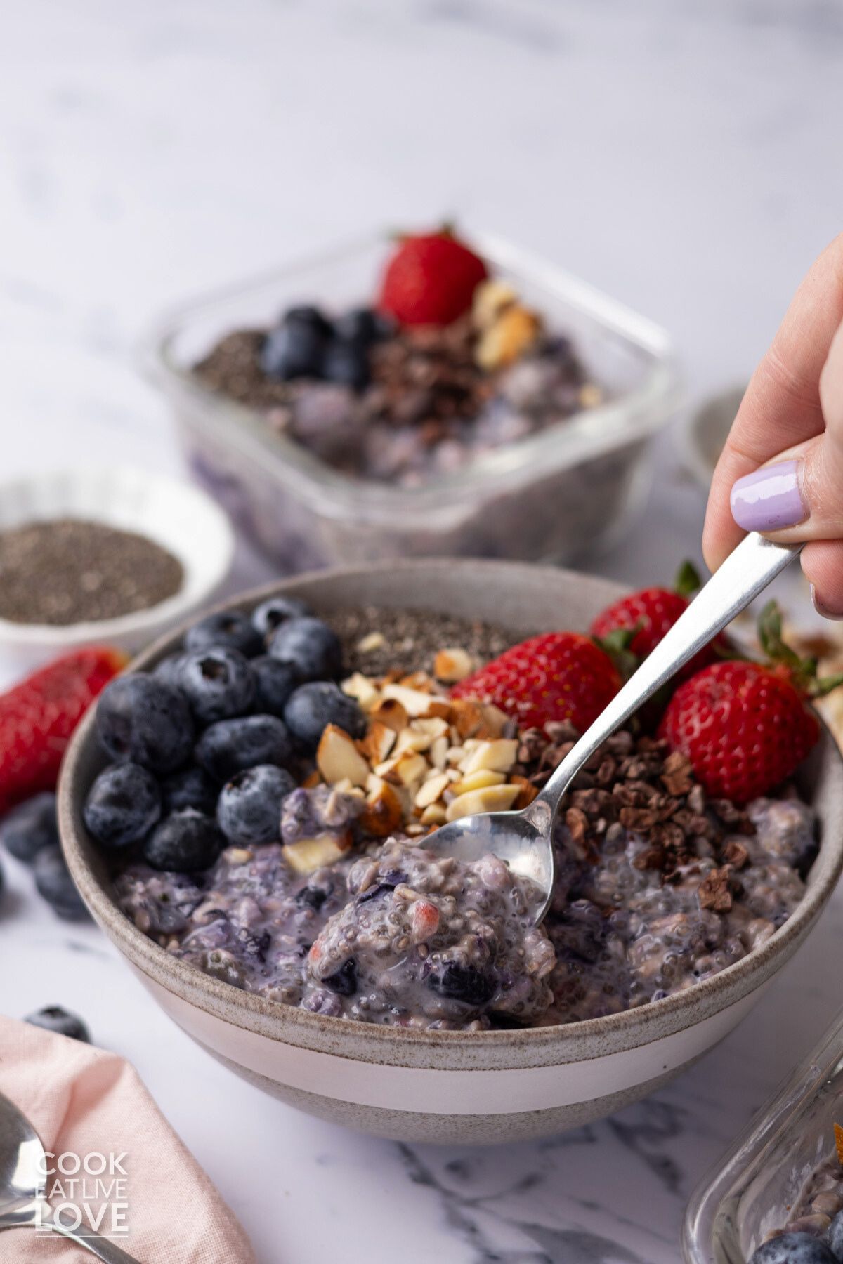 A spoon dipping into a bowl of chia overnight oats.