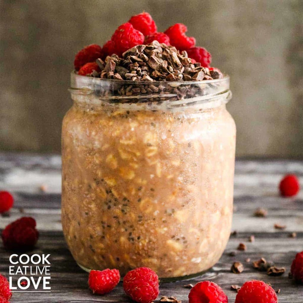 Chocolate raspberry overnight oats are ready to eat in a jar.