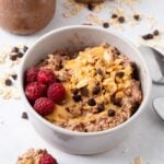 A bowl of peanut butter and jelly overnight oats on the table.