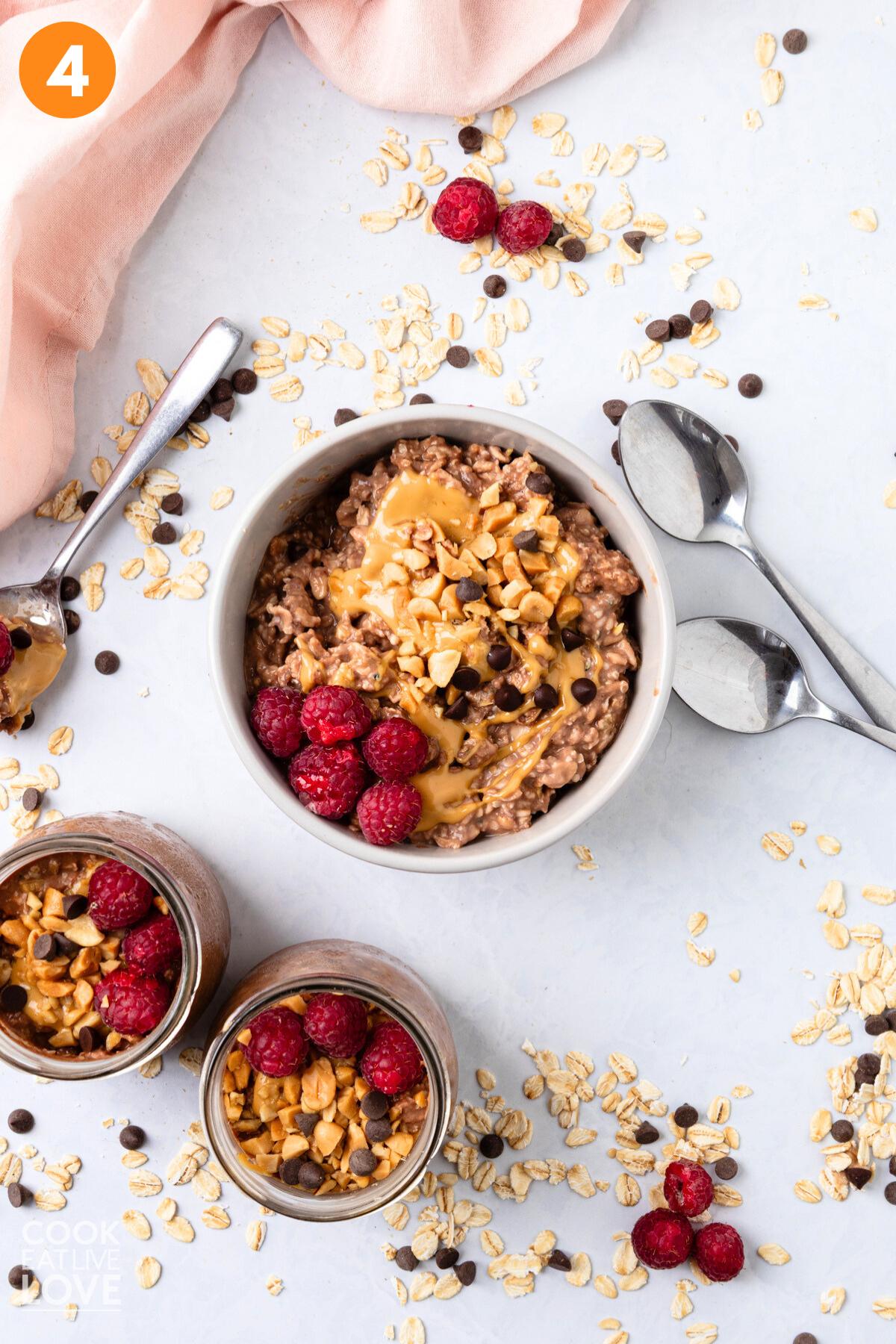A bowl of peanut butter and jelly overnight oats in a bowl with toppings added.