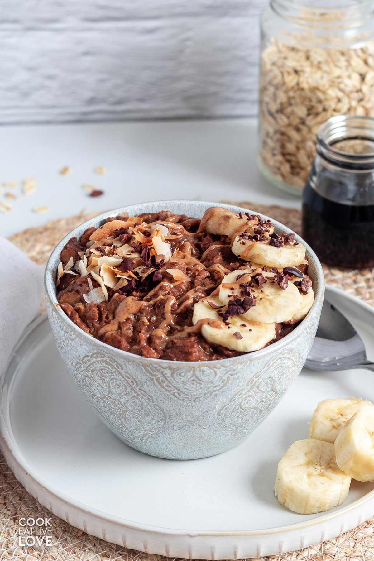 Chocolate oatmeal in a bowl with toppings