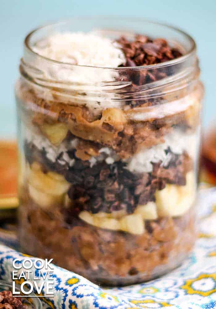 Banana oatmeal breakfast bowl is pictured in a jar for transport.