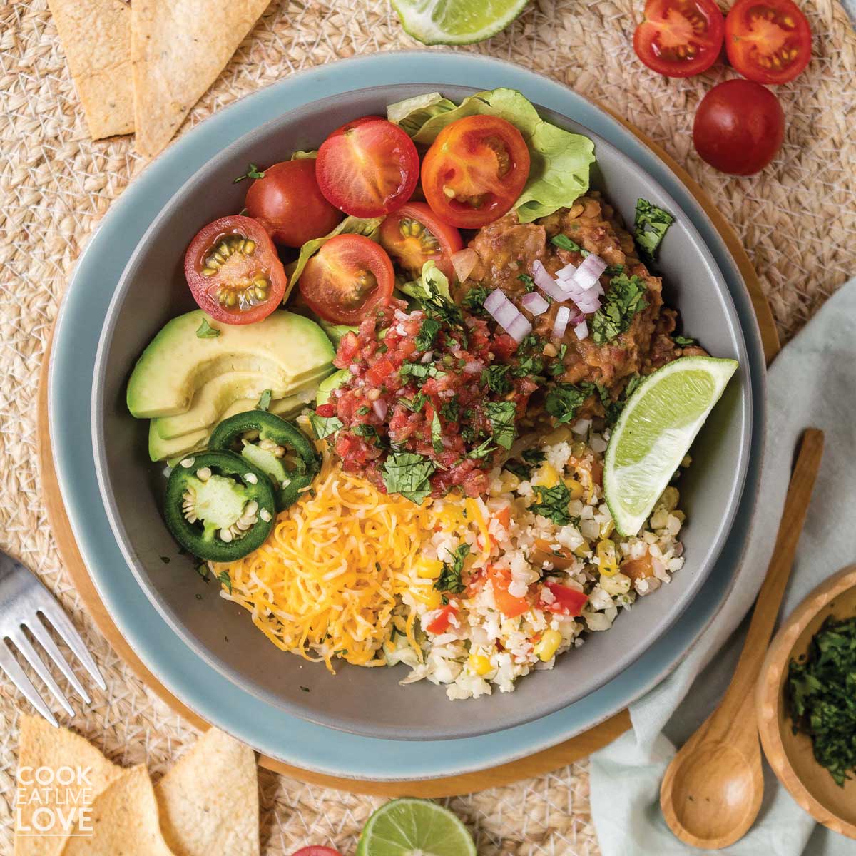 Overhead view of cauliflower rice burrito bowl served up on the table.