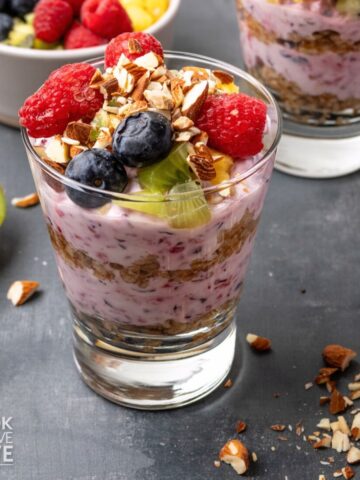 A breakfast parfait with berry flavored yogurt and oatmeal.