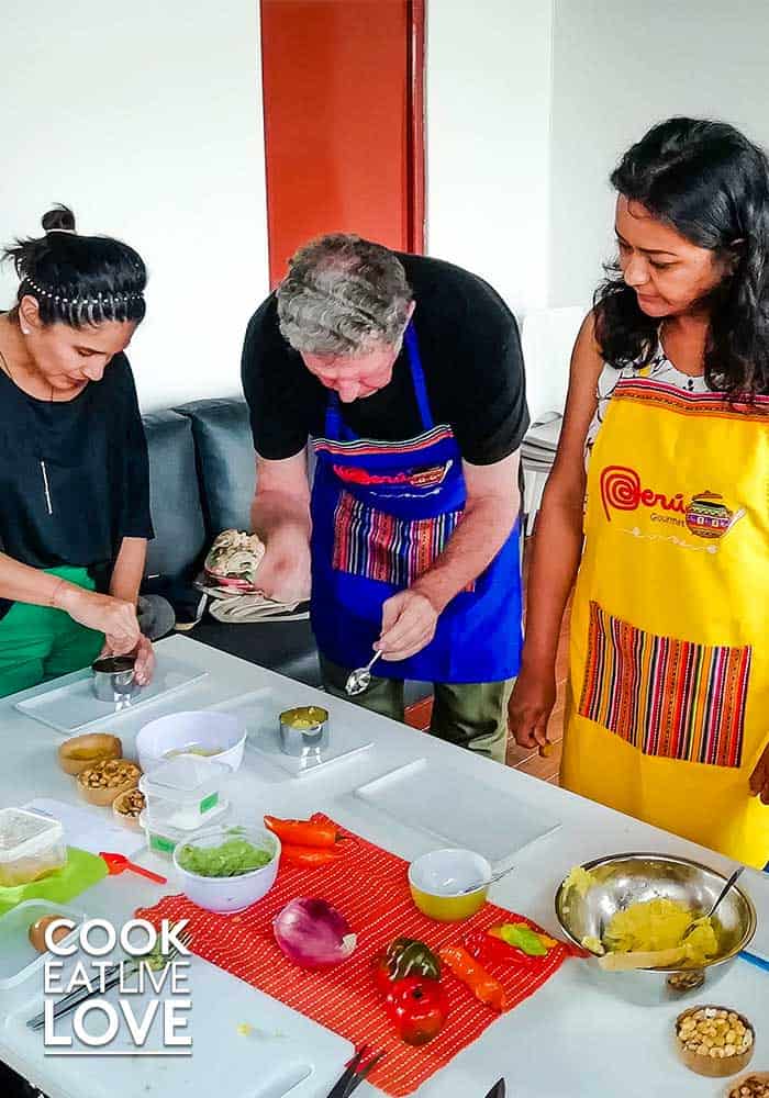 Students are assembling one of the dishes before sampling their Peruvian food creations.