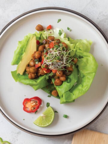 Vegetarian lettuce wraps with buffalo chickpeas are shown prepared and ready to eat.