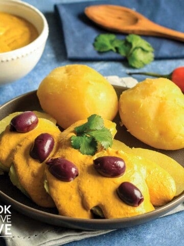 Potatoes topped with huancaina sauce.