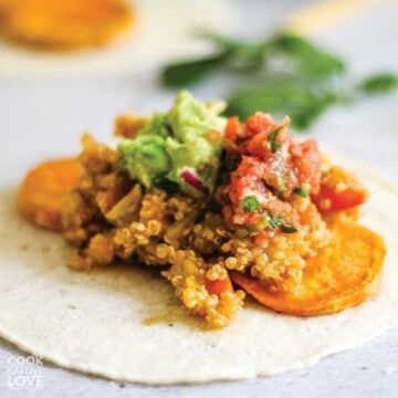 Corn tortilla on a table with sweet potatoes and quinoa