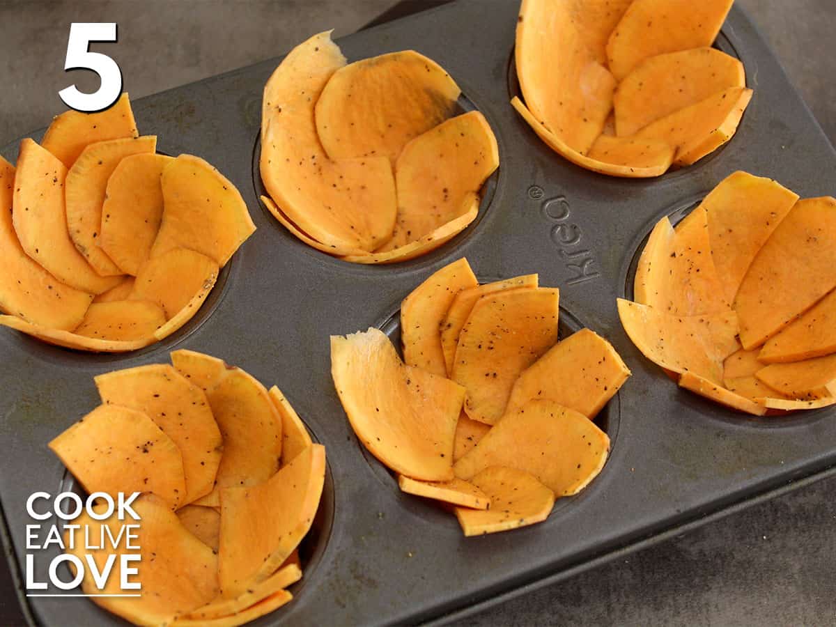 Cups in muffin pan are all lined with the sweet potato crust