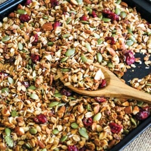 Green bowl filled with granola on a table