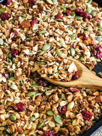 Green bowl filled with granola on a table