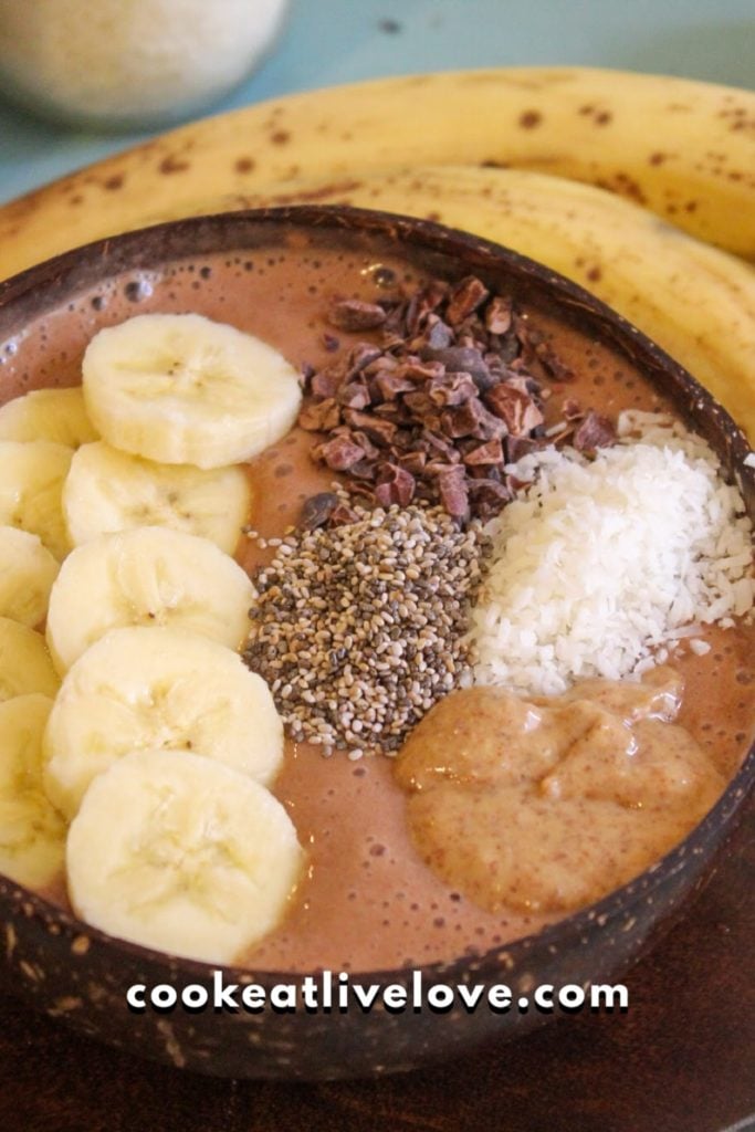 Overhead shot of finished cacao banana smoothie bowl, ready to eat.