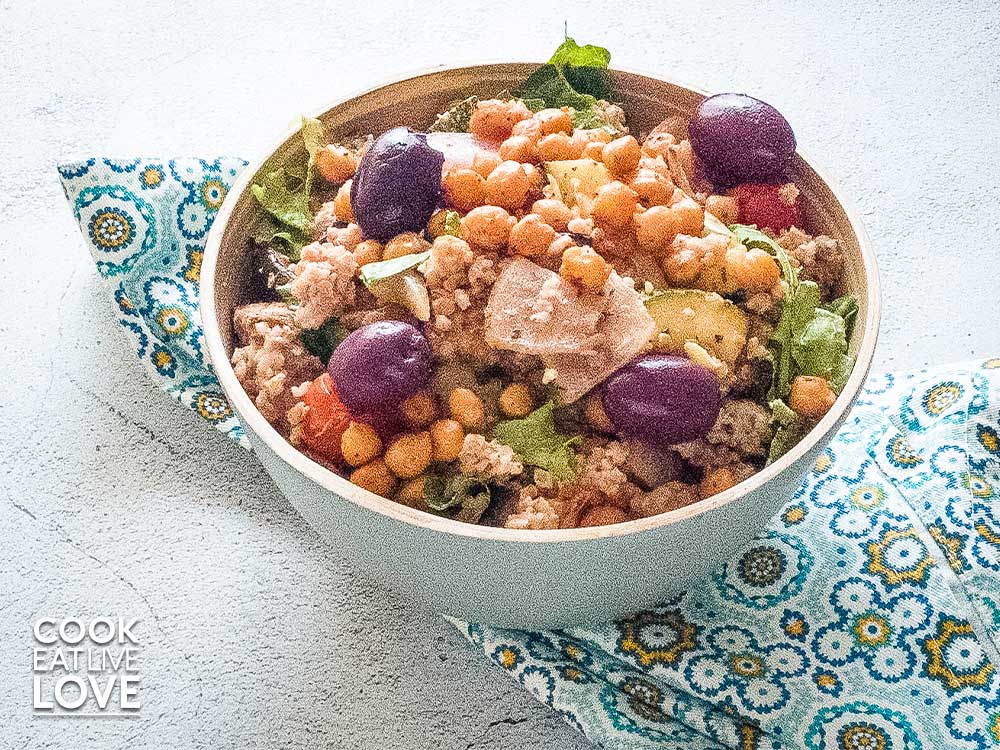 Bulgur chickpea bowl in a gray bowl on blue patterned napkin.
