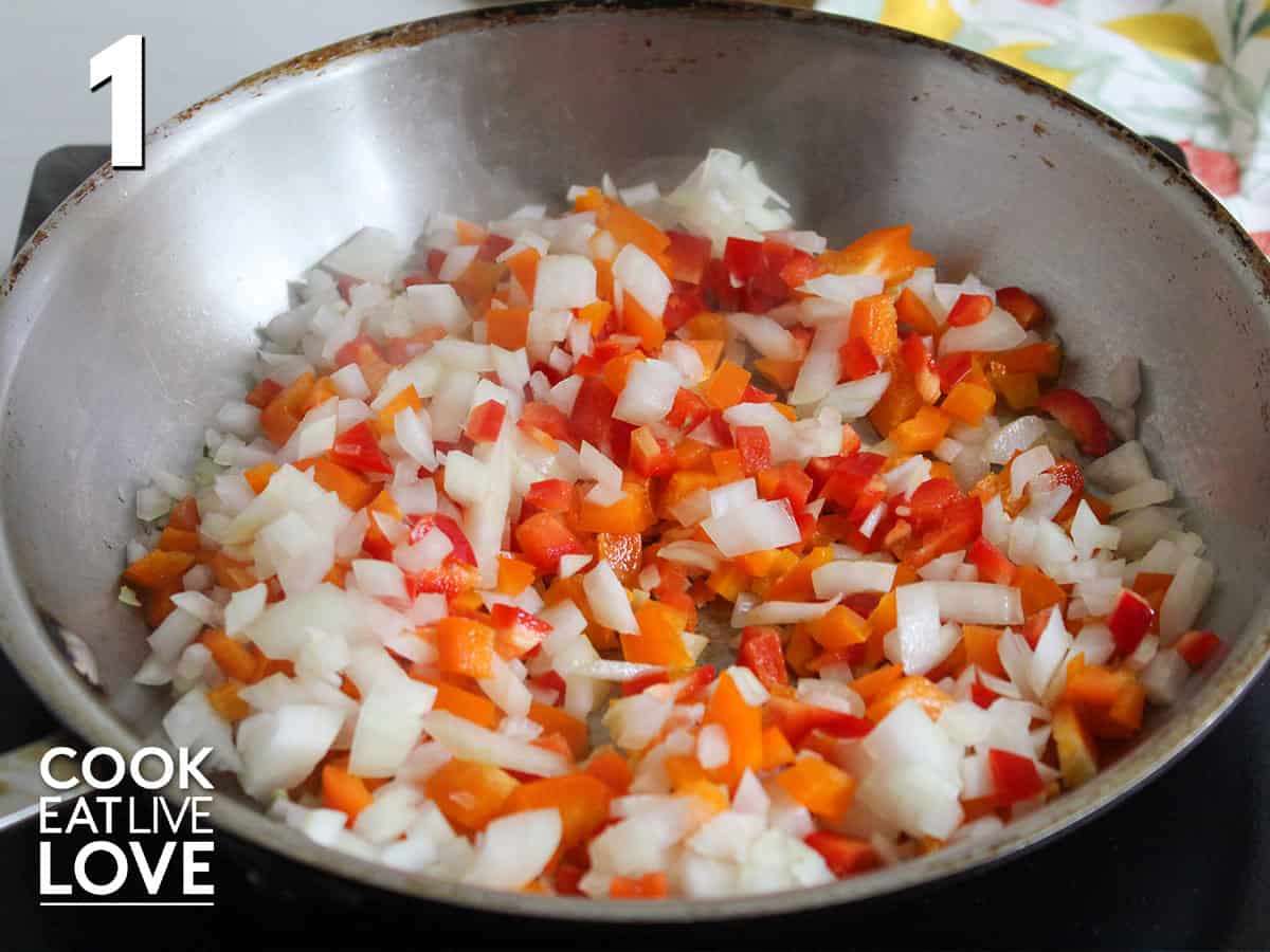 Onions and peppers in skillet to cook.