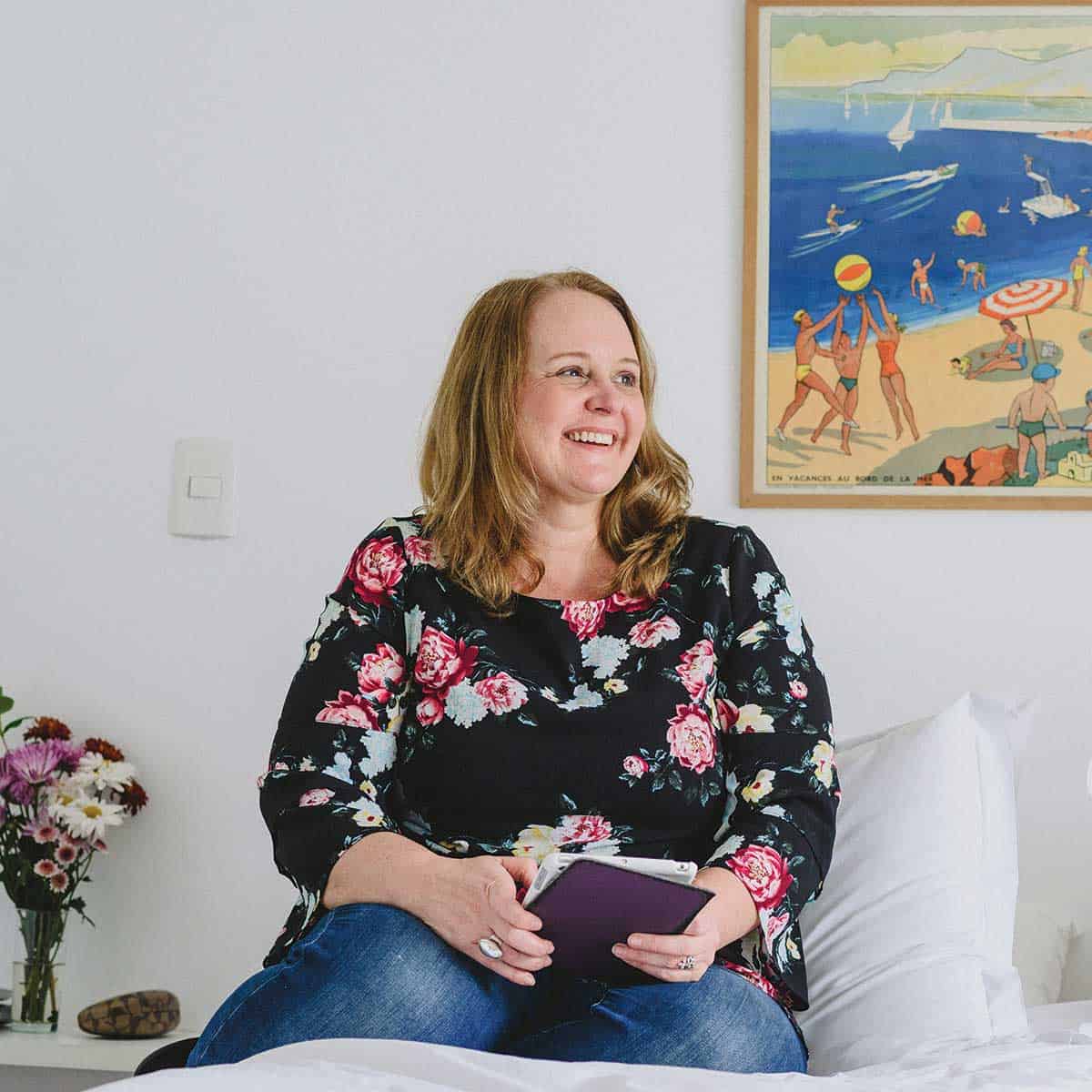 Lyn laughing with book in hand.