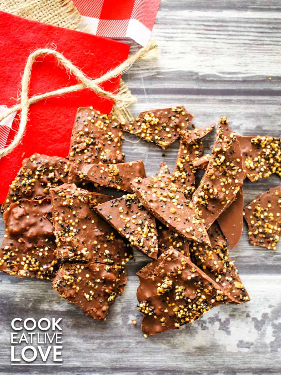 Quinoa chocolate bark is on a white and gray wood background 