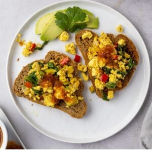 Tofu scramble and veggies on two slices of toast.