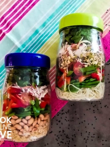Jars of asian salad on table